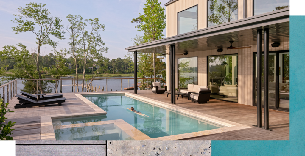 A woman swims in her pool adjacent to her custom modern barn home.